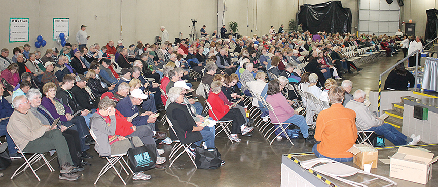 A warehouse filled with people playing bingo for prizes. 