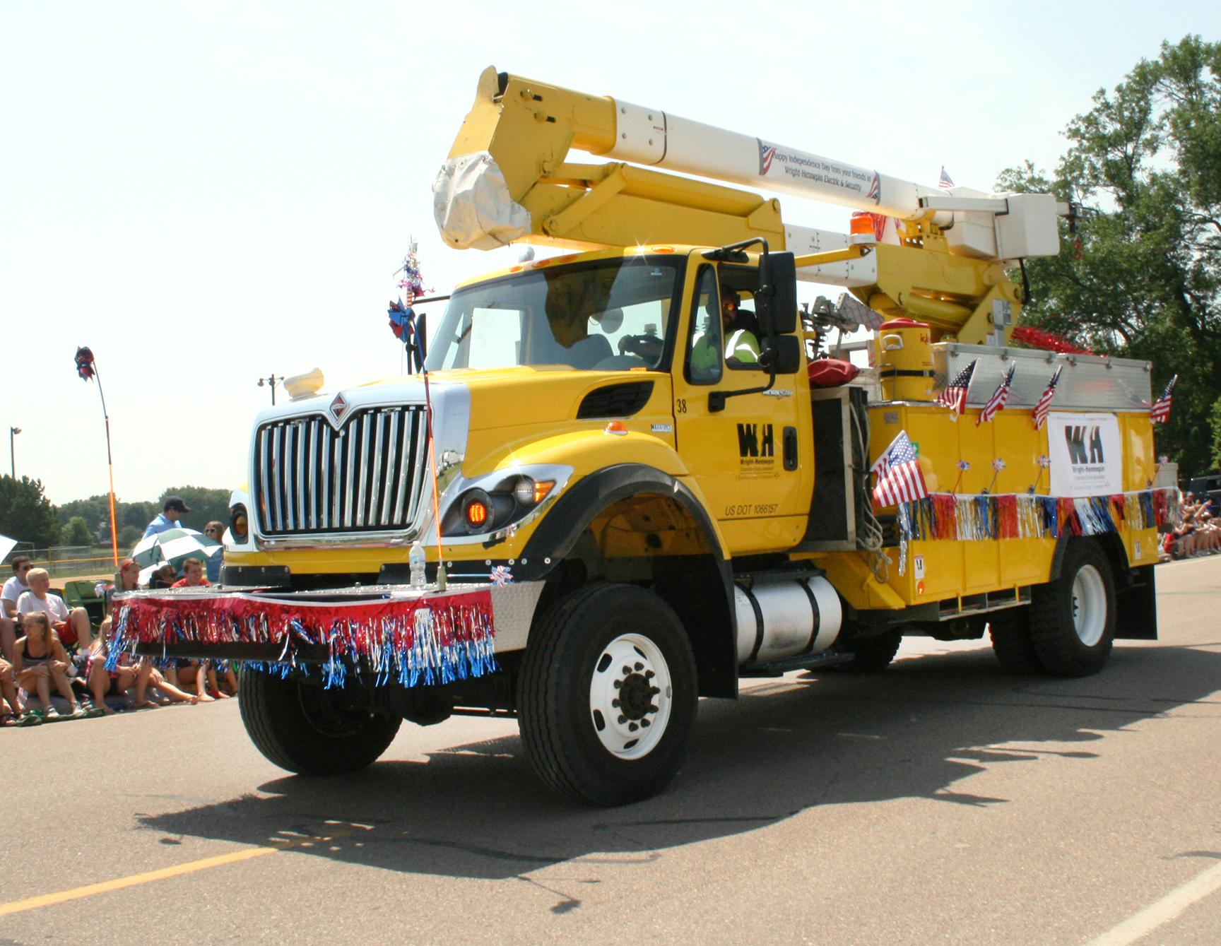 A WH line truck decorated in red, white, and blue for a local parade. 