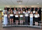 A group of 2023 scholarship winning students display scholarships given to them by Wright-Hennepin Electric