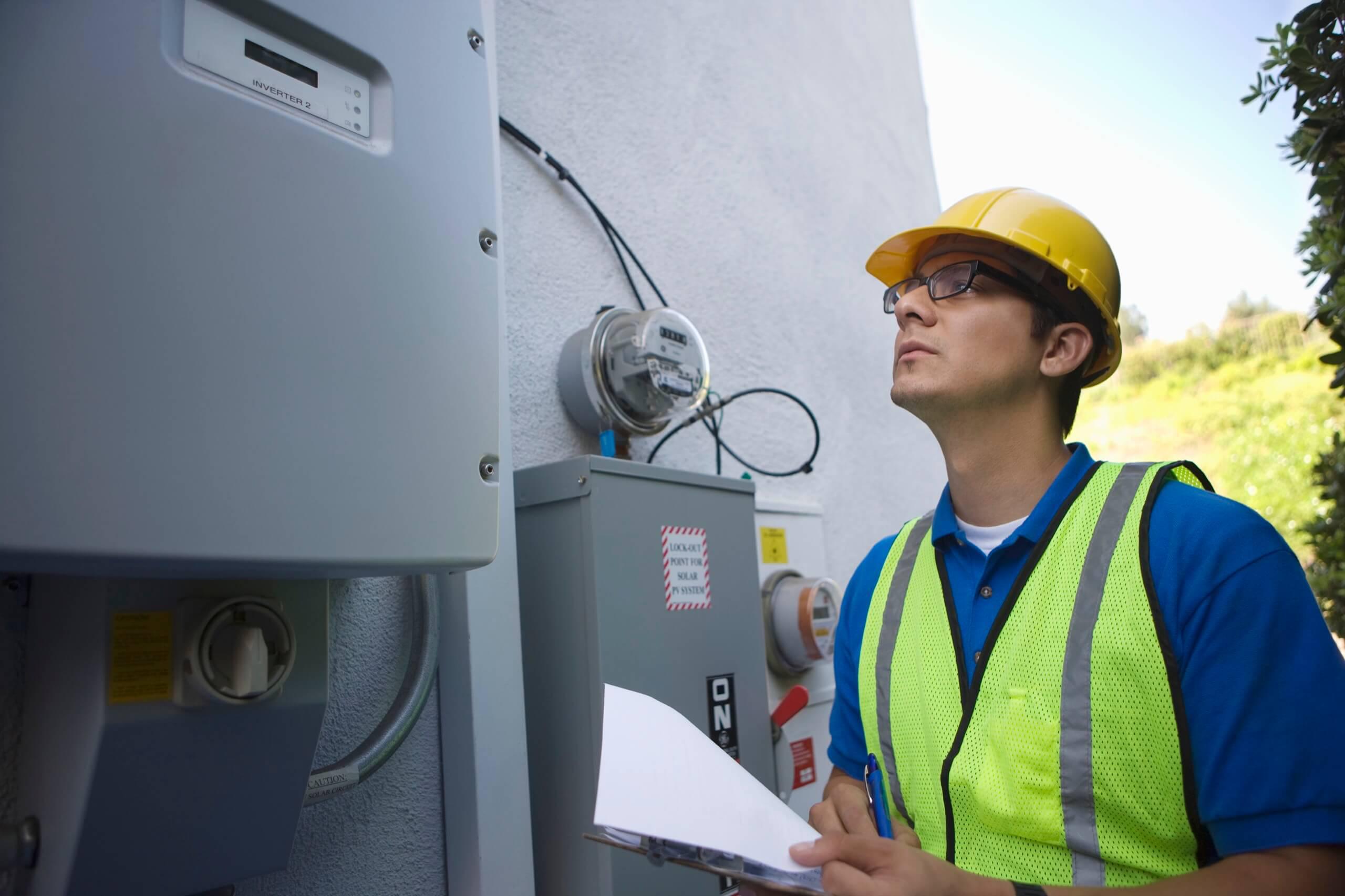 Wright-Hennepin Electric employee looks at electrical boxes