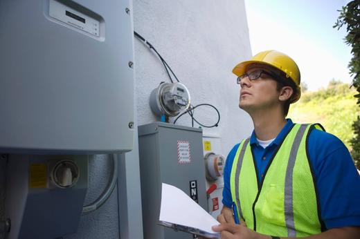 Wright-Hennepin Electric employee looks at electrical boxes