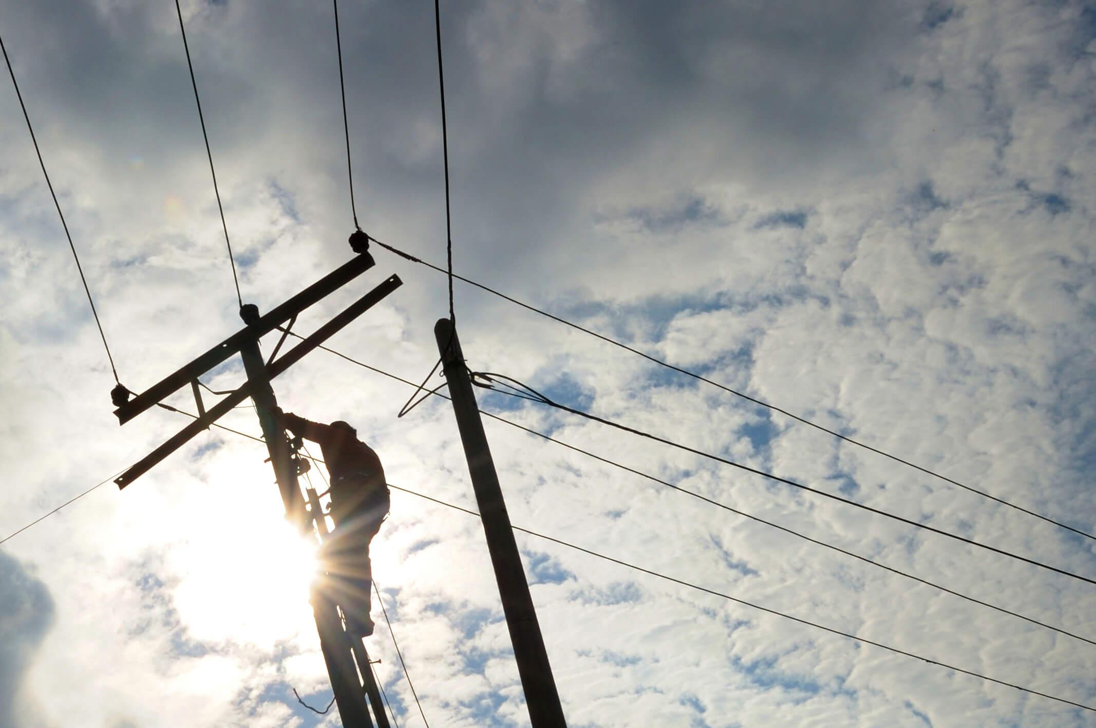 Wright-Hennepin Electric employee works on power lines