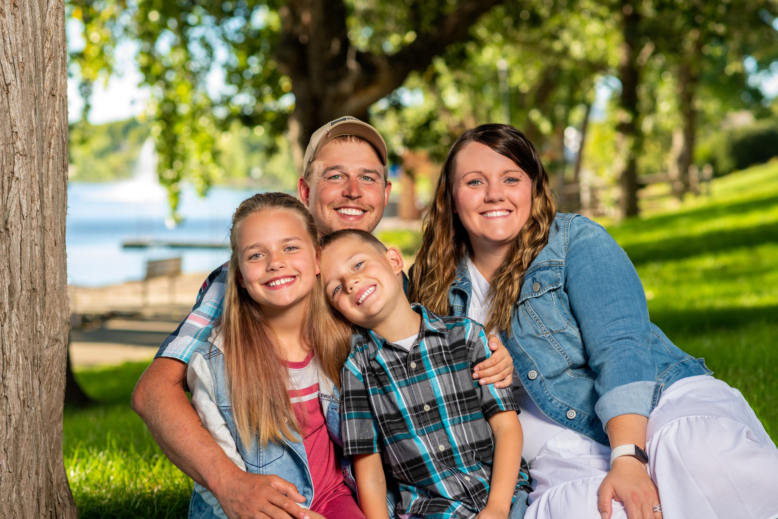 Family smiling in a park