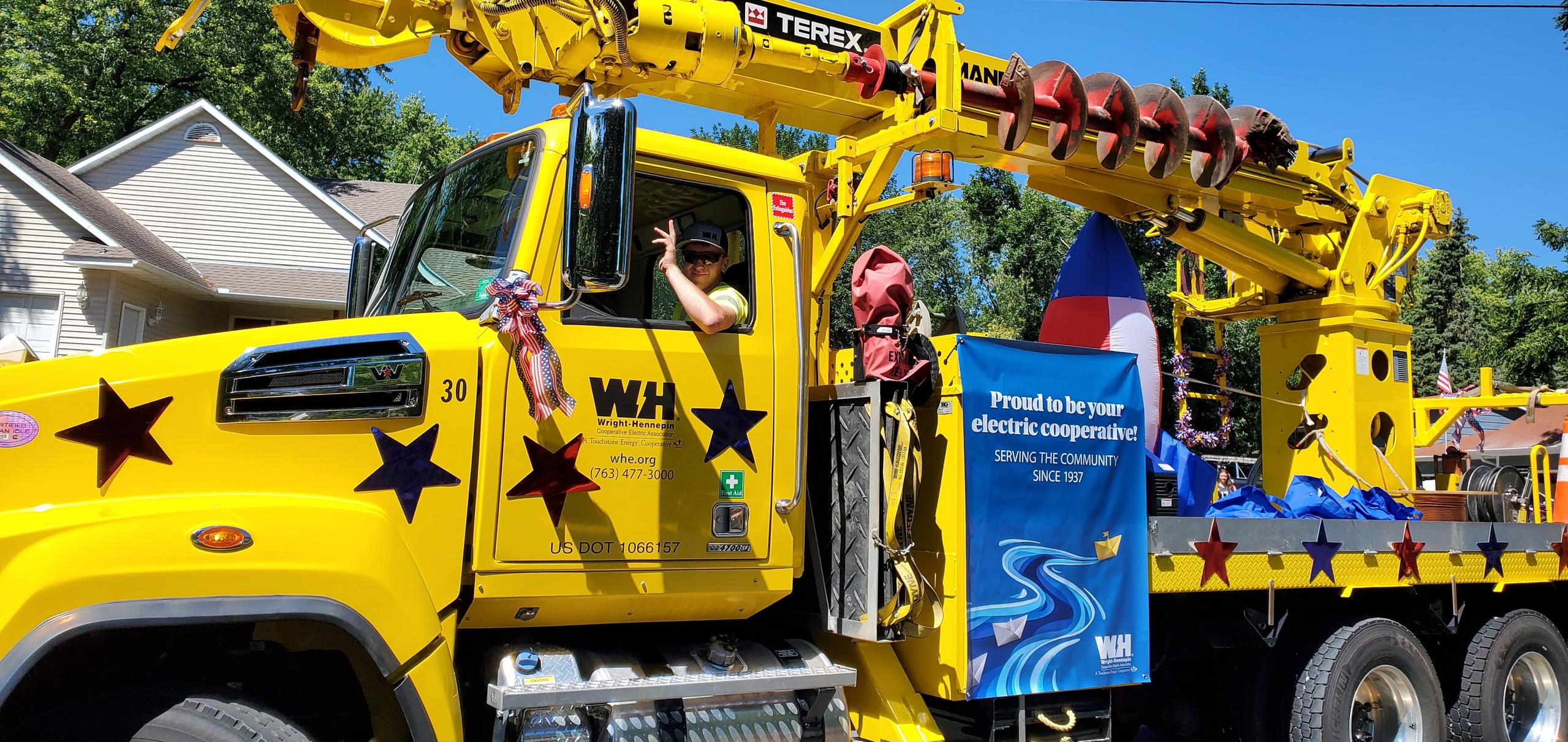 A WH truck decorated for a parade drives past the camera.