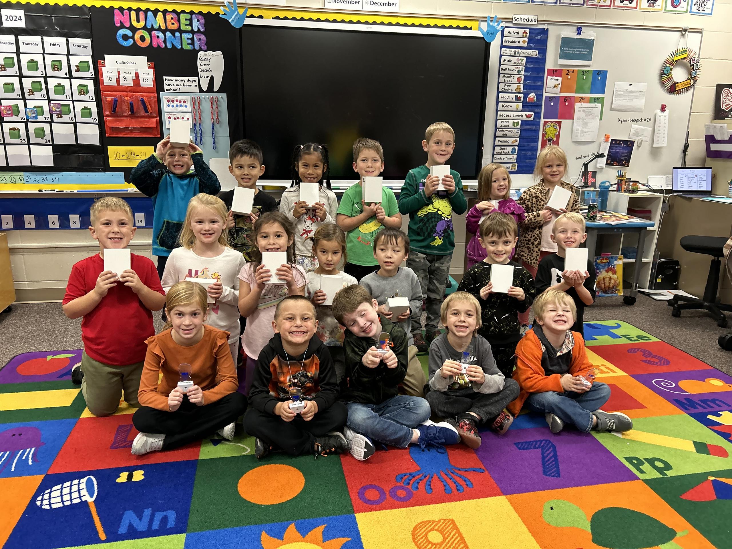 A classroom of students from Montrose Elementary School hold up their new nightlights.