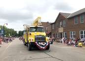 Wright-Hennepin Electric's aerial bucket truck goes through parade