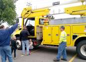 Kids ride on Wright-Hennepin Electric's aerial bucket truck