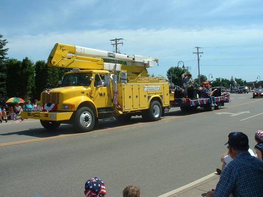 Wright-Hennepin Electric's truck hauls a float through a local parade