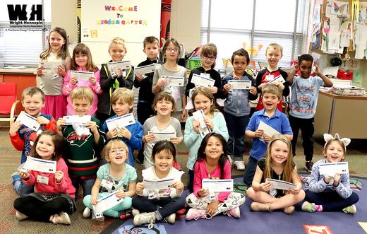 A classroom of students from Cedar Island Elementary School in Maple Grove hold up their new night lights.