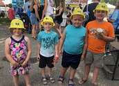 Children pose wearing Wright-Hennepin hard hats