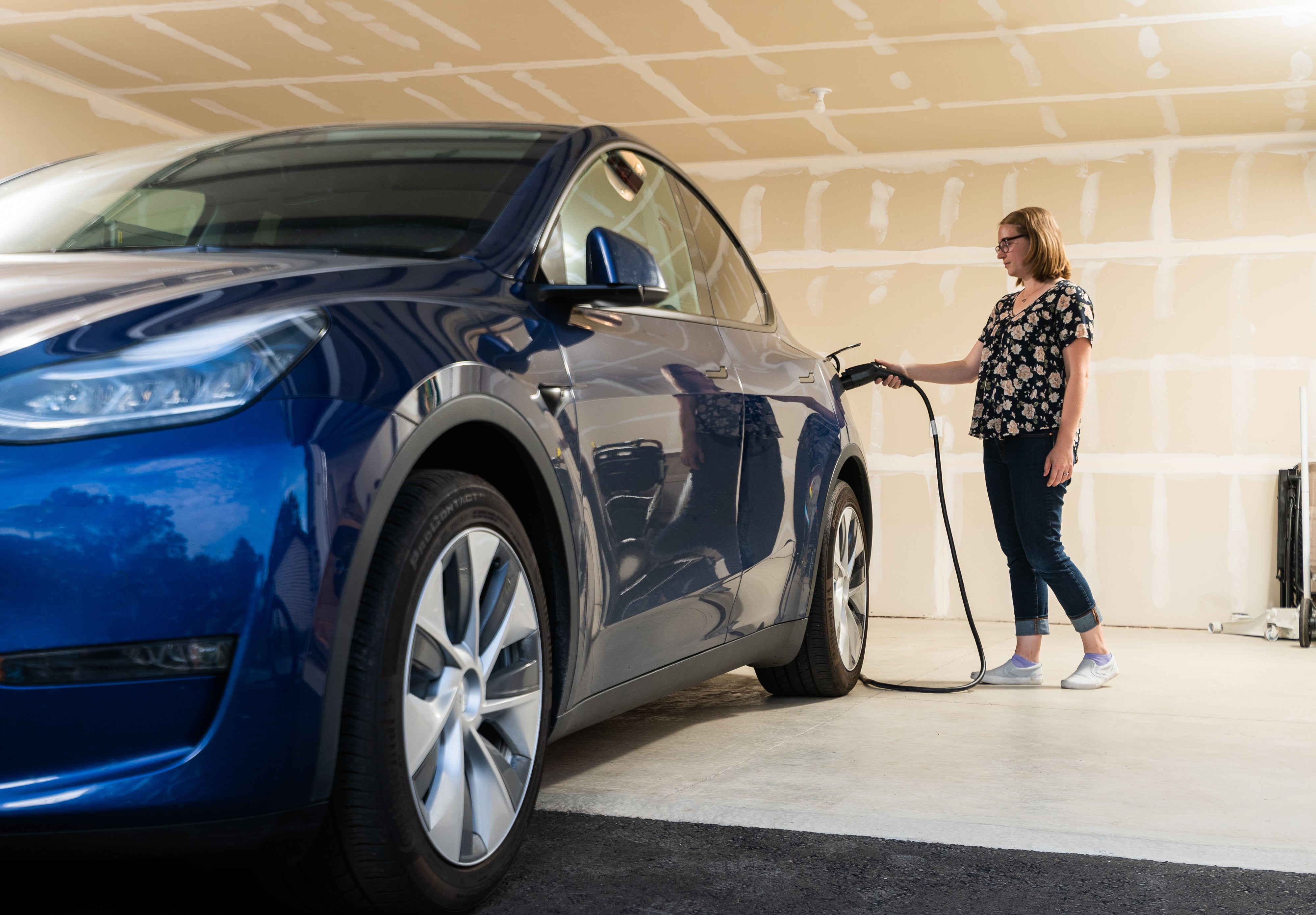 Woman charging an electric vehicle
