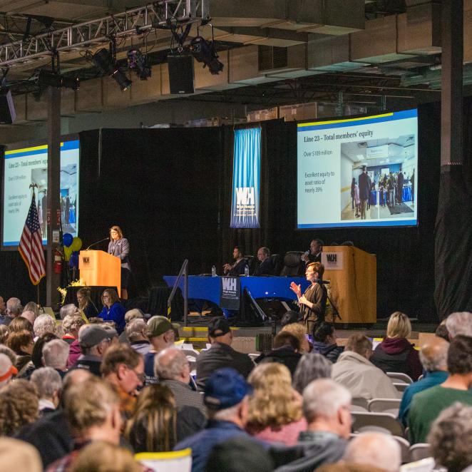A crowd of people watch a presentation during the 2025 Annual Meeting