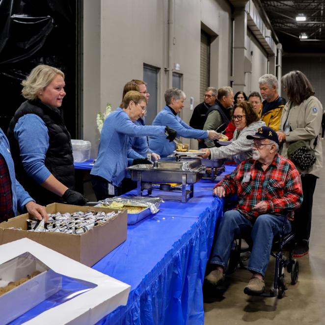 wright hennepin employees serve WH members at the member lunch