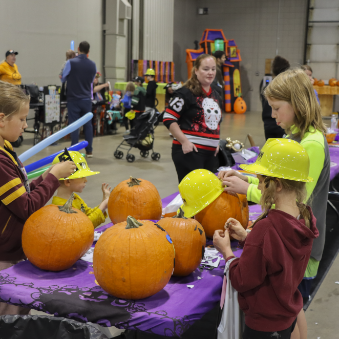 kids decorate pumpkins at Wright-Hennepin's fall festival