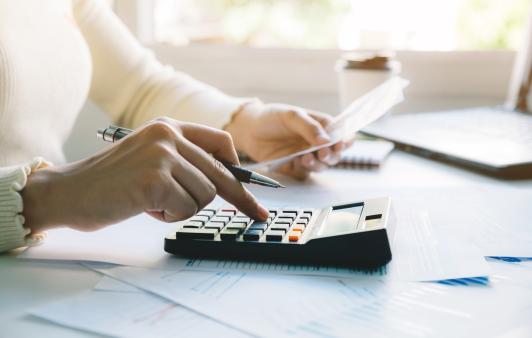 Woman calculating her taxes. 